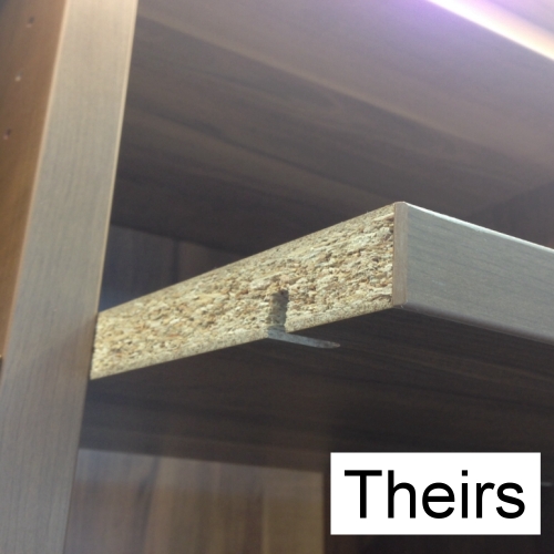 Side view of a particle board shelf showing the chunks of compressed wood and glue used in cheap closet systems